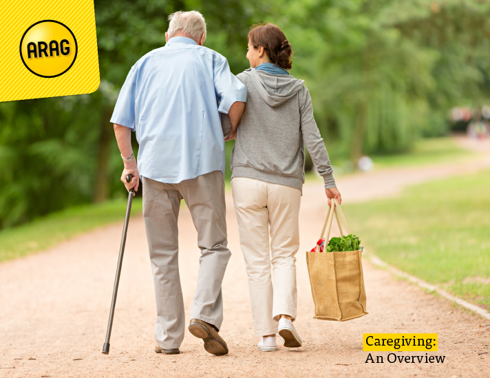 An elderly man walks with the assistance of a cane and his caregiver.